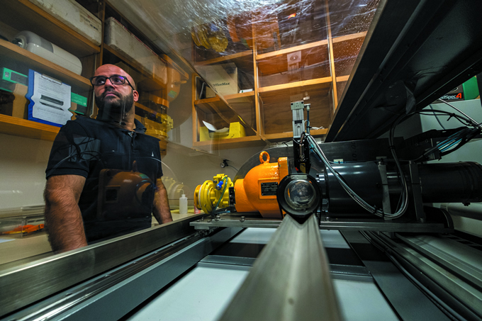 Palmerston North-based pedometrician Matteo Poggio operates the soil core scanner. Its sensor technologies rapidly scan soils and estimate soil organic carbon stocks.