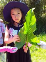Student with arum lily. Photographed by a student of Wakaaranga Primary School