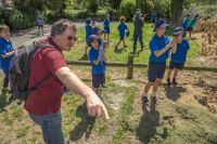 Murray Dawson pointing out weeds growing in the domain to Heathcote Valley School students (Kauri Team). Photo: Brad White