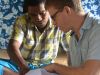 Andrew Daigneault reviews suvery data with enumerators in Fiji. Image - Pike Brown