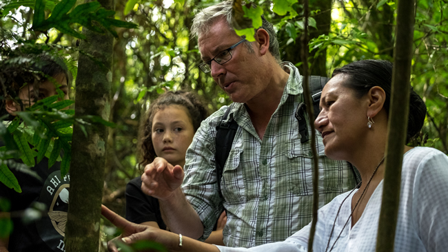 Dr Robert Hoare, Tiahuia Kawe-Small and students spotting moths in the forest