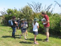 Fran Cohen and Murray Dawson with Paroa students finding plants in their school grounds. Photo: Hugh Gourlay, Manaaki Whenua - Landcare Research