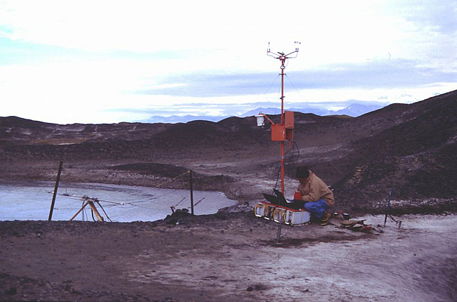 Ian Hawes downloading data from a climate station at Bratina Island.