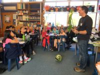 Murray Dawson discussing the weed arum lily with Manuka School students. Photo:  Monique Russell