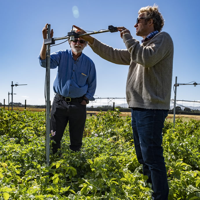 Plant & Food Research scientists Peter Jamieson (Left) and Hamish Brown (Right) testing the new sensor technology at the Lincoln trial site.
