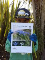 Student with agapanthus. Photographed by a student of Wakaaranga Primary School