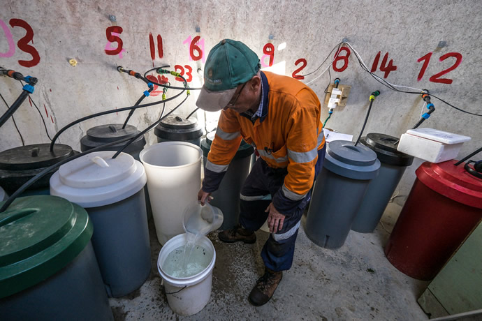 Malcolm McLeod measuring the waste collected from the large lysimeter on the farm in Tihoi.