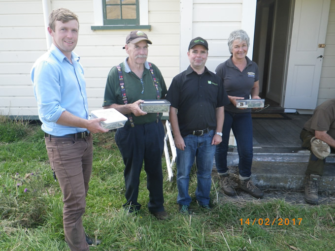 Happy farmers with Mike Cripps and their green thistle beetle starter colonies. Image: AgResearch