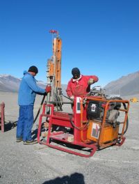 Drilling 20-m boreholes for installation of instruments for measuring permafrost temperature and stability. (Balks)