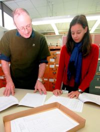 Research technicians Hamish Maule and Elise Arnst working with NVS records.