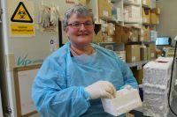 Dr Janine Duckworth with samples of ready-to-mate possum urine.