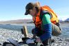 Sam Brown downloads footage from a camera-trap near the Cass River.