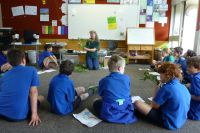 Robinne Weiss with Heathcote Valley School students (Kauri Team) explaining traditional uses of weeds. Photo: Murray Dawson