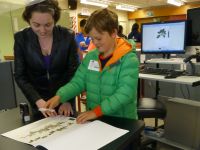 Kate Boardman helping a student to digitise his mounted specimen
