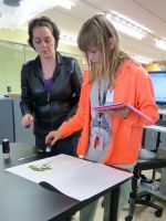 Kate Boardman helping a student to digitise her mounted specimen