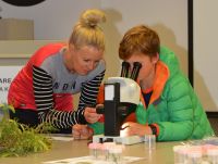 Student and his mother examining biocontrol insects