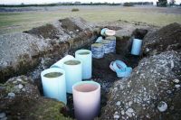 Stony soil lysimeter barrels before being lifted out.