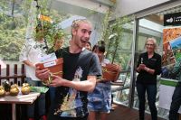 Connor Boyle, Gabrielle Young and Ashlyn Baum hug the trees they were awarded for their concept Treehuggers.  