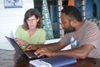 Suzie Greenhalgh translating survey forms with Jale Tauraga, Fiji Ministry of Fisheries and Forests. Image – Pike Brown.